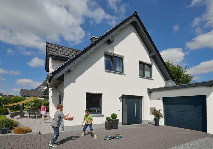 exterior shot of modern home with children playing on driveway